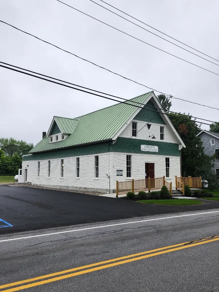 The Charlton Community Center, a white clapboard building with a green roof